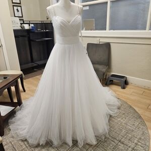 Size 10 white tulle full Aline bridal gown with silver trim. NWT